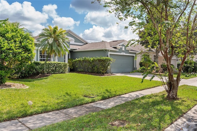 view of front of home with a garage and a front lawn