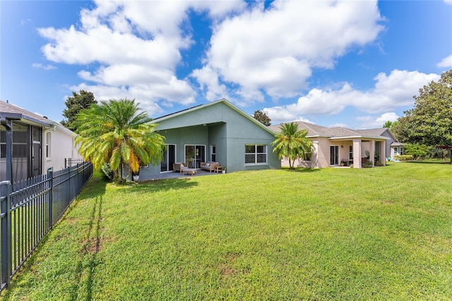 back of house featuring a yard and a patio area