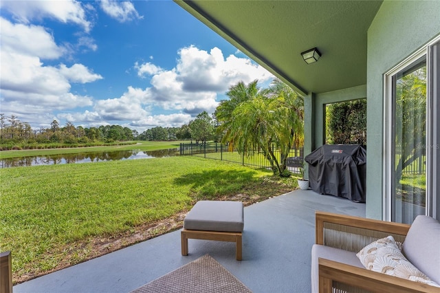 view of patio / terrace with a water view and area for grilling