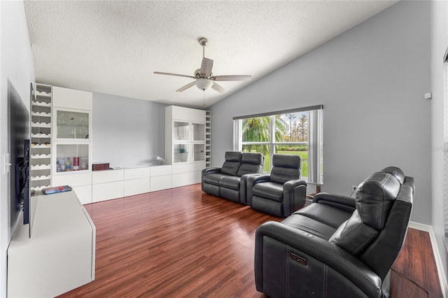 living room featuring ceiling fan, a textured ceiling, lofted ceiling, and hardwood / wood-style floors