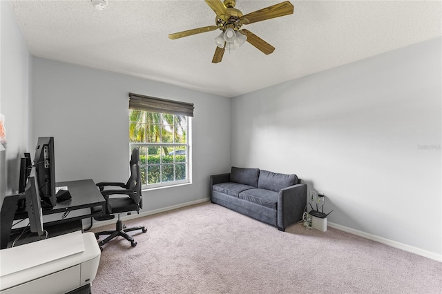 carpeted office with ceiling fan and a textured ceiling