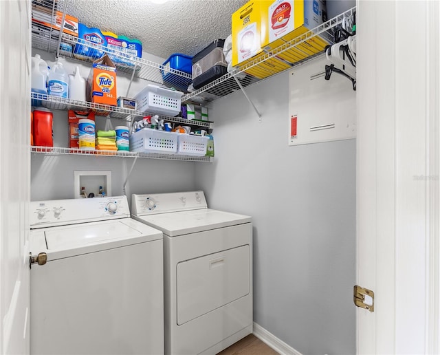 laundry room with washer and dryer and a textured ceiling