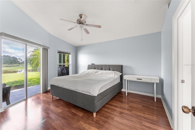 bedroom with access to outside, vaulted ceiling, dark hardwood / wood-style flooring, and ceiling fan