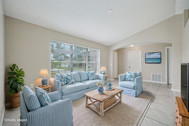 tiled living room featuring lofted ceiling