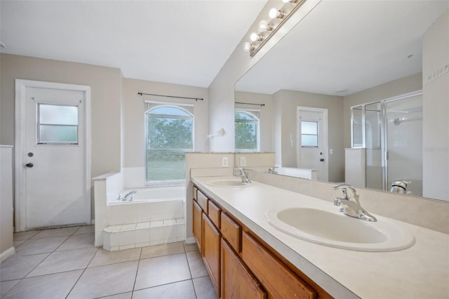 bathroom with independent shower and bath, vanity, and tile patterned flooring