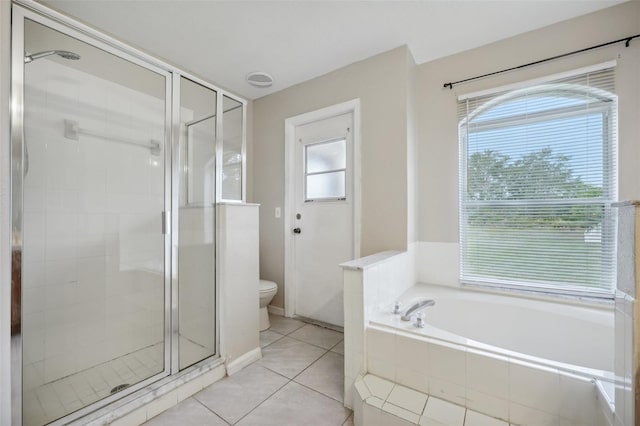 bathroom featuring independent shower and bath, tile patterned flooring, and toilet