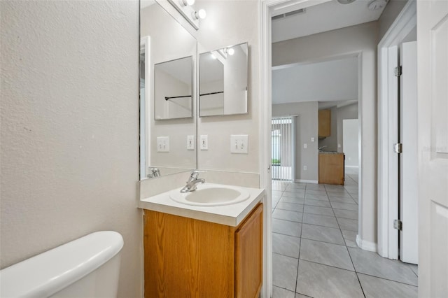 bathroom featuring tile patterned floors, vanity, and toilet