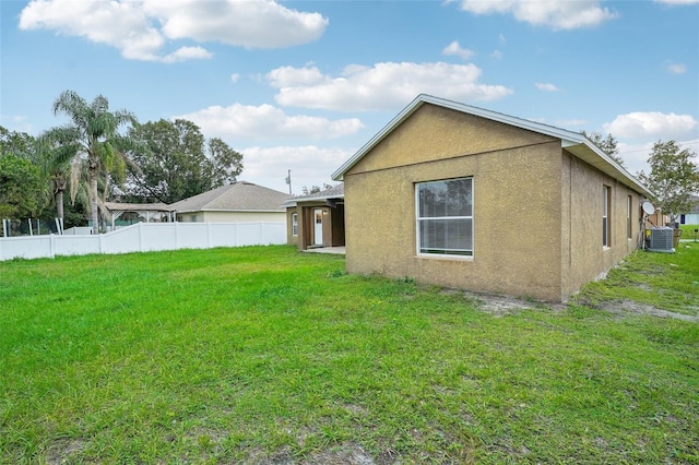 exterior space with a yard and central AC unit