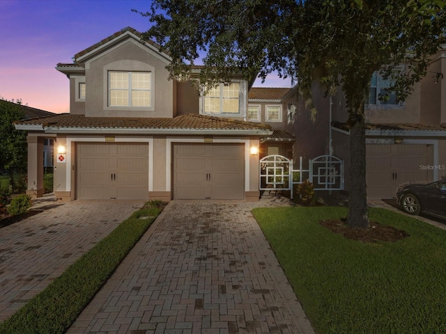 view of front of home featuring a garage and a yard