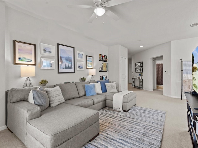 carpeted living room featuring ceiling fan