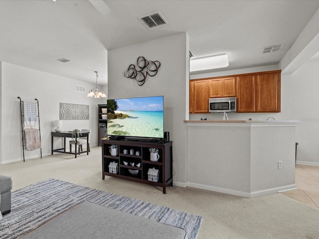 living room with a notable chandelier and light carpet