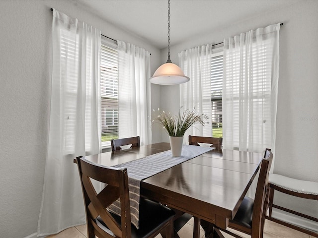 dining space featuring light tile patterned floors