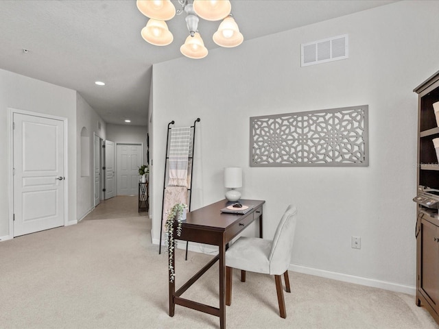 office space with light colored carpet and a chandelier