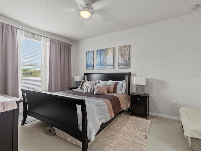 bedroom featuring ceiling fan and light carpet