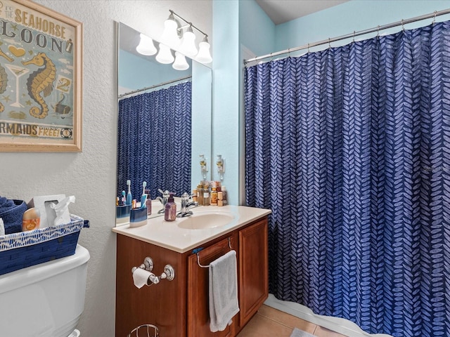 bathroom featuring tile patterned floors, vanity, and toilet