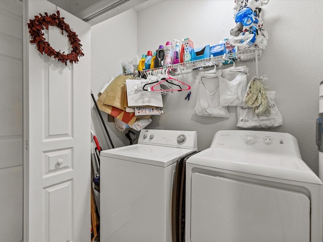 clothes washing area with separate washer and dryer