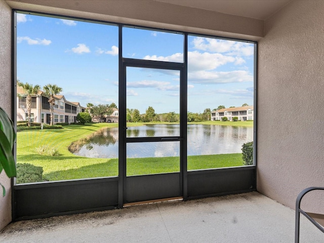 unfurnished sunroom featuring a water view