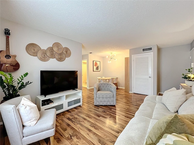 living room with a textured ceiling and hardwood / wood-style flooring