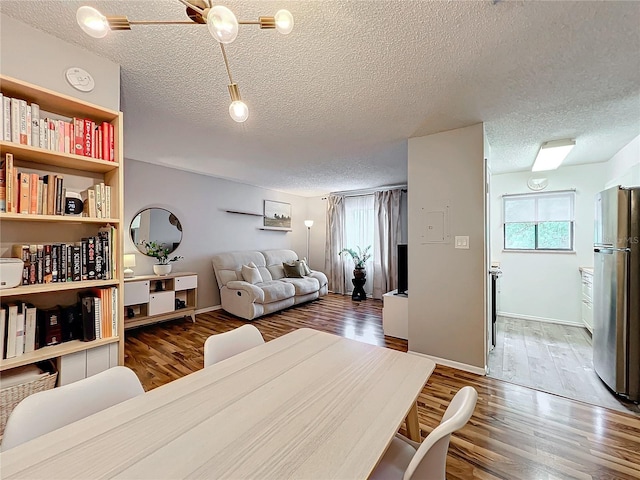 dining room with ceiling fan, a textured ceiling, and dark hardwood / wood-style flooring