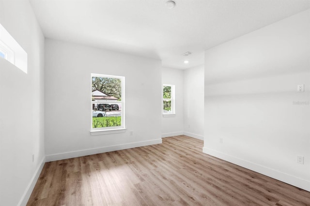 empty room with light hardwood / wood-style flooring