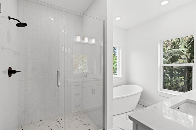 bathroom featuring vanity and separate shower and tub