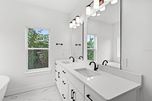 bathroom with vanity, a tub, and plenty of natural light