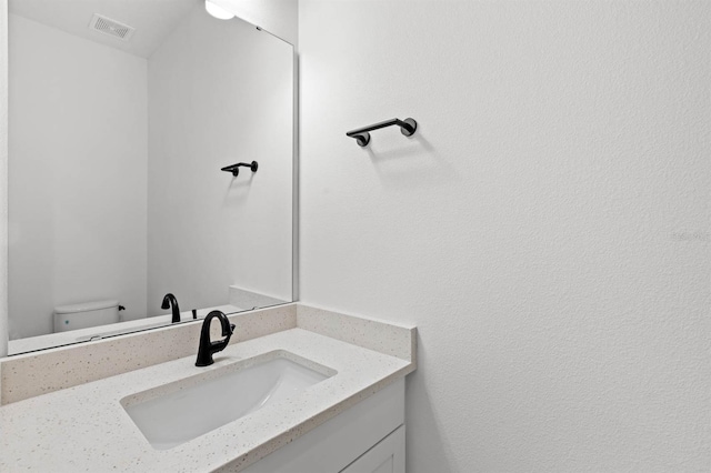 bathroom with toilet and vanity