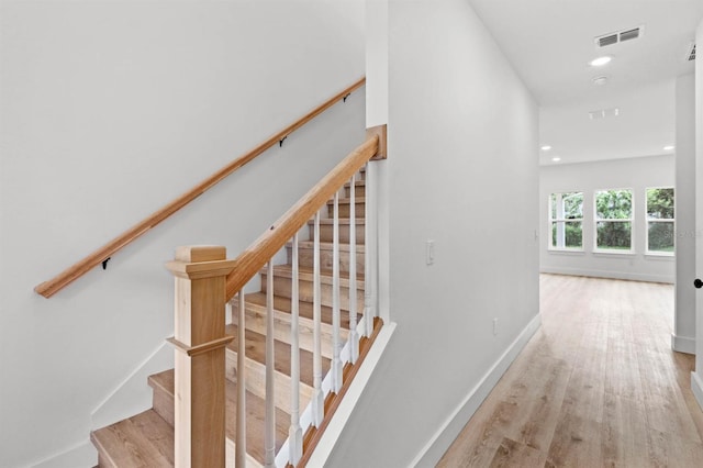 stairway with hardwood / wood-style flooring