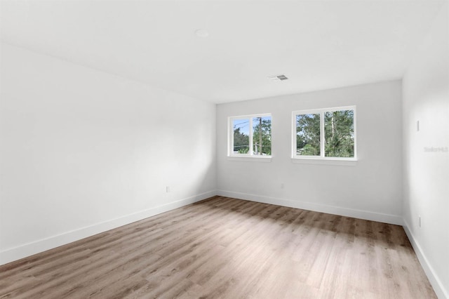 spare room with light hardwood / wood-style flooring