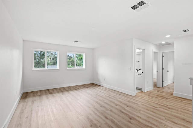 empty room with light hardwood / wood-style flooring