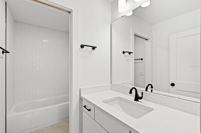 bathroom featuring vanity, tiled shower / bath combo, and tile patterned flooring