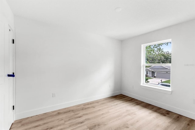 unfurnished room with light wood-type flooring