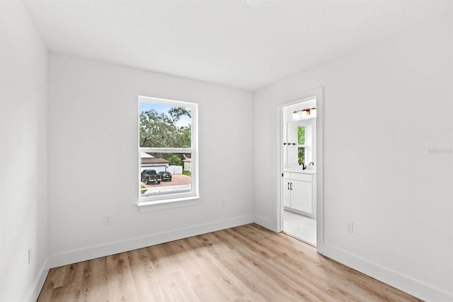 spare room with light hardwood / wood-style flooring