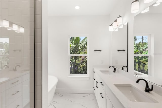 634 Burch Ave, Winter Garden, FL 34787 - full bath with marble finish floors, a freestanding bath, double vanity, a stall shower, and baseboards
