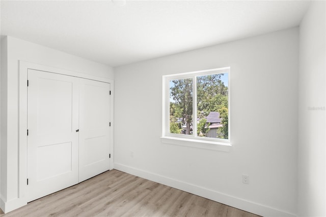 634 Burch Ave, Winter Garden, FL 34787 - unfurnished bedroom with baseboards, light wood finished floors, and a closet