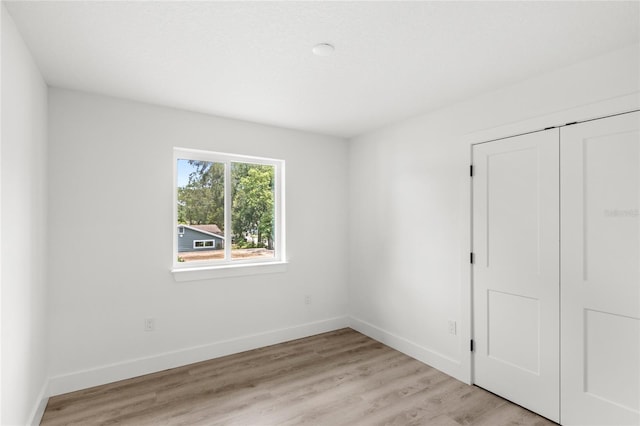 634 Burch Ave, Winter Garden, FL 34787 - unfurnished bedroom with a closet, baseboards, and light wood-type flooring
