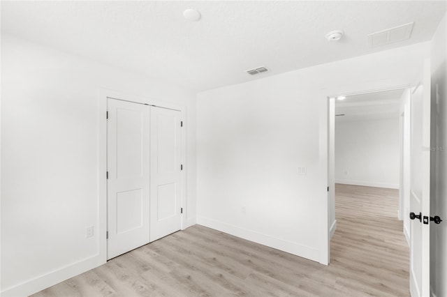 634 Burch Ave, Winter Garden, FL 34787 - unfurnished bedroom with light wood finished floors, baseboards, and a closet