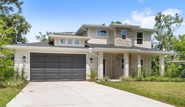 634 Burch Ave, Winter Garden, FL 34787 - prairie-style house featuring stone siding, concrete driveway, a front lawn, and roof with shingles