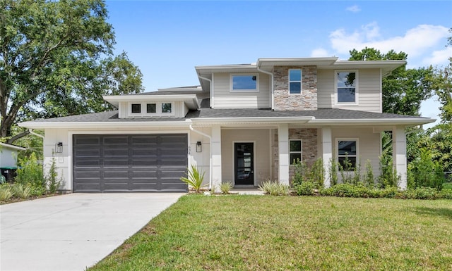 634 Burch Ave, Winter Garden, FL 34787 - prairie-style home featuring concrete driveway, a front yard, an attached garage, stone siding, and roof with shingles