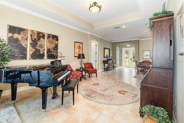 misc room with ornamental molding, a tray ceiling, french doors, and light tile patterned floors