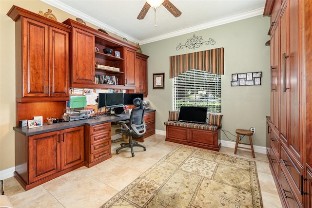 home office featuring ornamental molding, ceiling fan, and built in desk