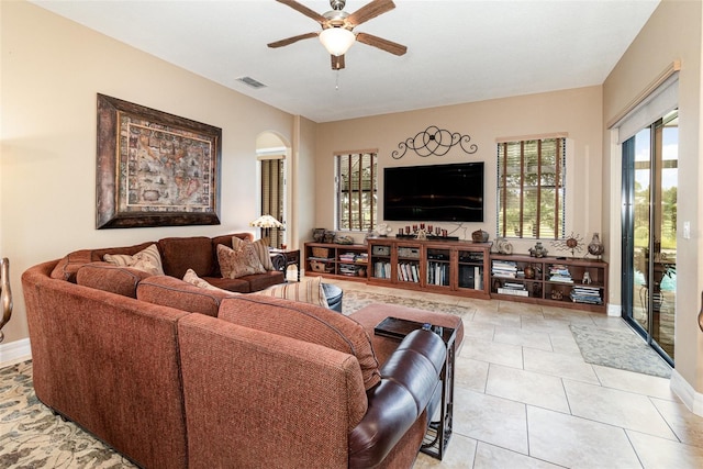 living room with ceiling fan and light tile patterned floors