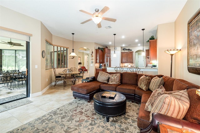 living room featuring light tile patterned floors and ceiling fan