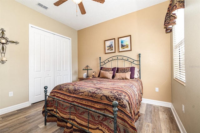 bedroom featuring a closet, hardwood / wood-style floors, and ceiling fan