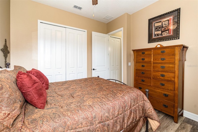 bedroom with wood-type flooring, a closet, and ceiling fan