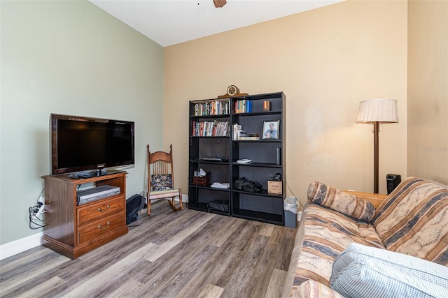 living room featuring ceiling fan, vaulted ceiling, and hardwood / wood-style floors