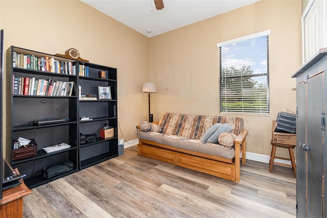 sitting room with light hardwood / wood-style floors and ceiling fan