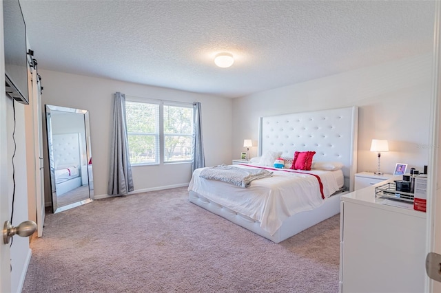 carpeted bedroom featuring a textured ceiling