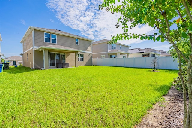 back of property featuring a yard