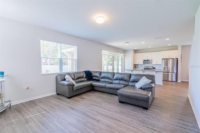 living room with light hardwood / wood-style floors